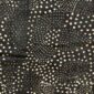 Close-up of the dark mudcloth with swirling arcs of pale dots