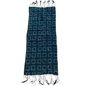 Full view of the small dark mudcloth with a grid of pale crosses and chevrons on a white background