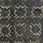 Close-up of the dark mudcloth with a grid of pale crosses and chevrons