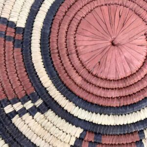 bashiri-placemat-178-harmony-burkina-platter-woven-2 Close-up of the coiled raffia weave and centre of the rust, black and natural Burkina platter with a wheel pattern