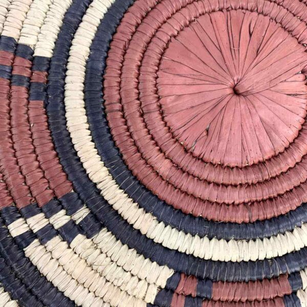 bashiri-placemat-178-harmony-burkina-platter-woven-2 Close-up of the coiled raffia weave and centre of the rust, black and natural Burkina platter with a wheel pattern