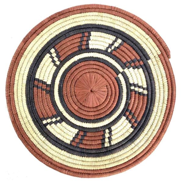 bashiri-placemat-178-harmony-burkina-platter-woven-3 Full view of the rust, black and natural Burkina platter with a wheel pattern on a white background
