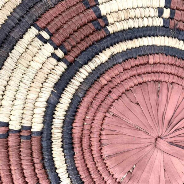 bashiri-placemat-181-serenity-burkina-platter-handwoven-2 Close-up of the coiled raffia weave and centre of the rust, black and natural Burkina platter with a ring pattern
