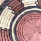 Close-up of the coiled raffia weave and centre of the rust, black and natural Burkina platter with a ring pattern