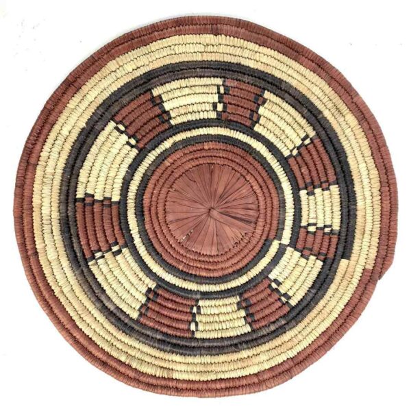 bashiri-placemat-181-serenity-burkina-platter-handwoven-3 Full view of the rust, black and natural Burkina platter with a ring pattern on a white background