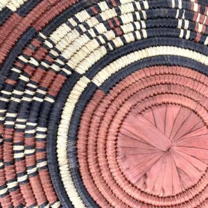 bashiri-placemat-182-sunbeam-burkina-platter-woven-2 Close-up of the coiled raffia weave and centre of the rust, black and natural Burkina platter with a starburst pattern