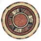 Full view of the rust, black and natural Burkina platter with a starburst pattern on a white background