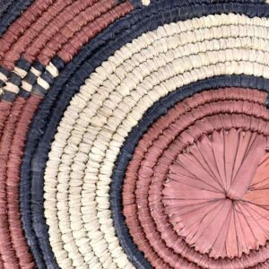 bashiri-placemat-184-delight-woven-raffia-platter-2 Close-up of the coiled raffia weave and centre of the rust, black and natural Burkina platter with a hook pattern