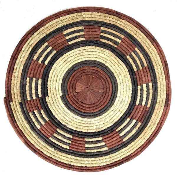 bashiri-placemat-185-tranquil-burkina-platter-handwoven-3 Full view of the rust, black and natural Burkina platter with a band pattern on a white background