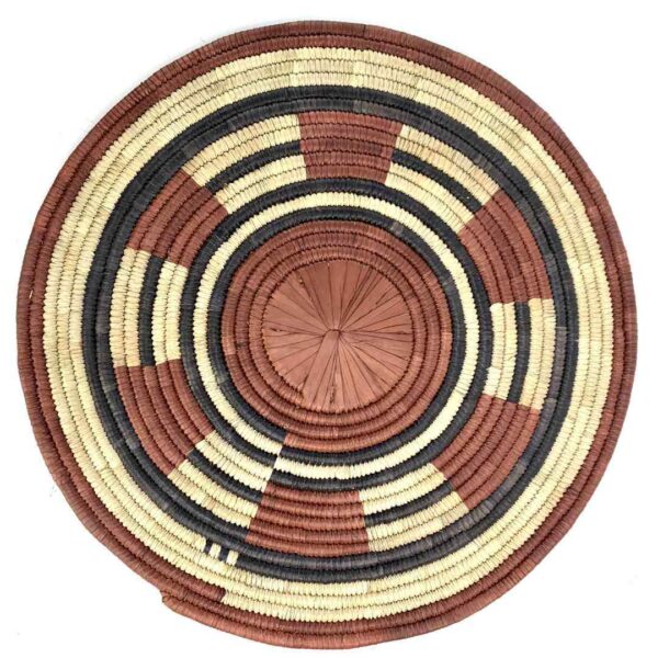 bashiri-placemat-187-joy-african-platter-raffia-3 Full view of the rust, black and natural Burkina platter with a segment pattern on a white background