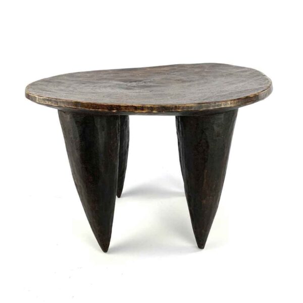 bashiri-senufo-stool-ivorycoast-066-kpatscha-african-stool-wooden-2 Front view of the dark hardwood Senufo stool with an oval seat and four tapered legs on a white background