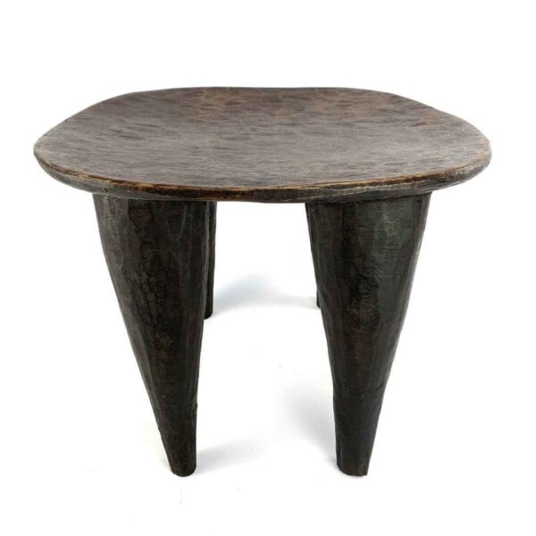 bashiri-senufo-stool-ivorycoast-067-baga-african-stool-hand-carved-2 Front view of the dark hardwood Senufo stool with a rounded square seat on a white background