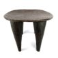 Front view of the dark hardwood Senufo stool with a rounded square seat on a white background