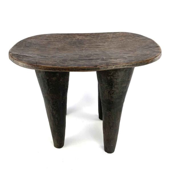 bashiri-senufo-stool-ivorycoast-069-lift-african-stool-wooden-2 Front view of the tall dark hardwood Senufo stool with four long tapered legs on a white background