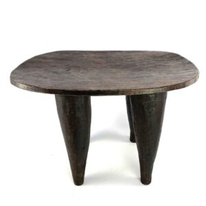 Front view of the dark hardwood Senufo stool with a broad, dished seat on a white background