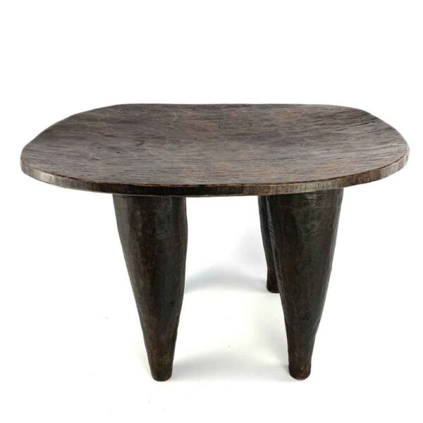 bashiri-senufo-stool-ivorycoast-070-steady-african-stool-hand-carved-2 Front view of the dark hardwood Senufo stool with a broad, dished seat on a white background