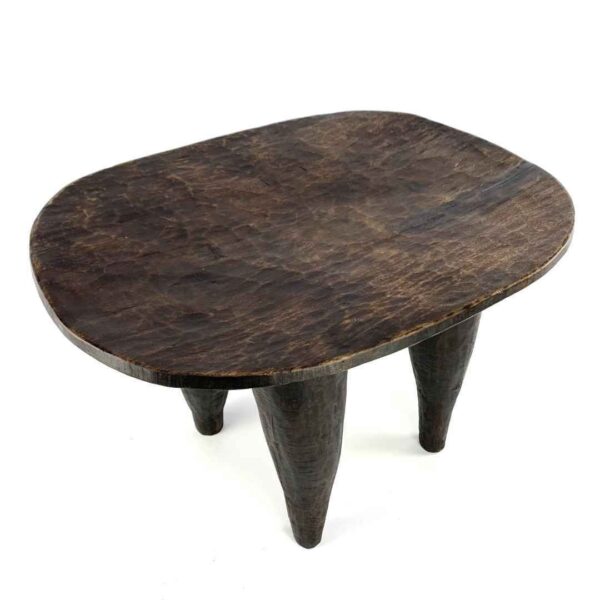 bashiri-senufo-stool-ivorycoast-070-steady-african-stool-hand-carved-3 Angled view of the carved seat of the dark hardwood Senufo stool with a broad, dished seat