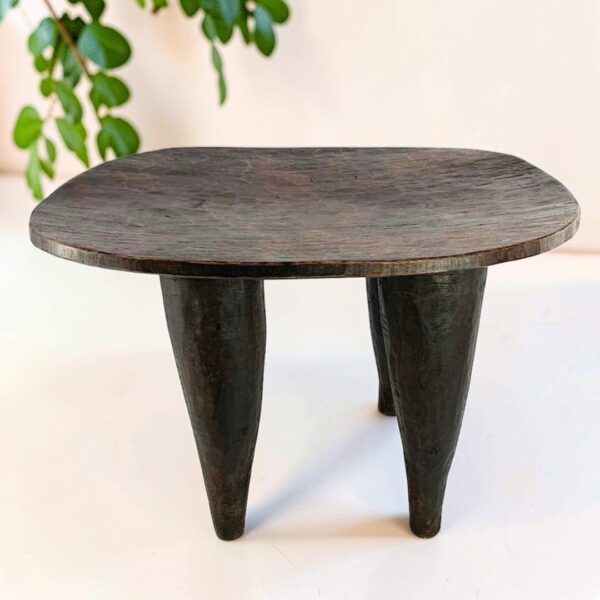 bashiri-senufo-stool-ivorycoast-070-steady-african-stool-hand-carved-main Dark hardwood Senufo stool with a broad, dished seat, styled beside a plant