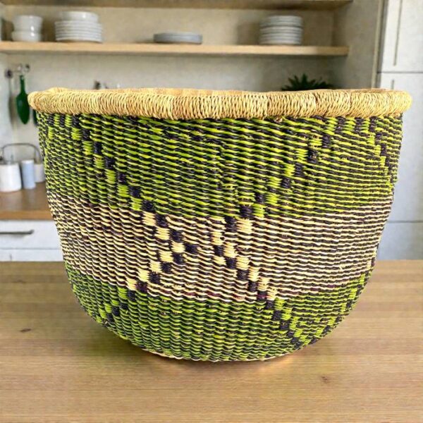 bashiri-uba-bolga-basket-green-purple-natural Large Uba Bolga basket in green, purple and natural straw with woven geometric pattern, styled on a timber table