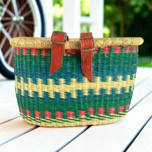 Green Bolga bike basket with red zigzag trim and natural stepped band, leather straps and buckles