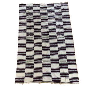 Detail of the horizontal striped pattern with an open-weave dot band on this handwoven Sahel cotton blanket