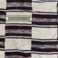 Detail of the horizontal striped pattern with an open-weave dot band on this handwoven Sahel cotton blanket