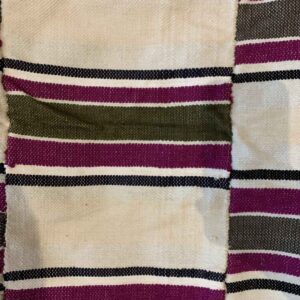 Detail of the broad striped pattern with a dotted accent band on this handwoven Sahel cotton blanket