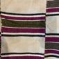 Detail of the broad striped pattern with a dotted accent band on this handwoven Sahel cotton blanket