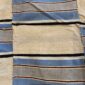 Detail of the fine multi-tone striped pattern with a fringed edge on this handwoven Sahel cotton blanket