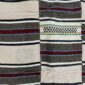 Detail of the striped pattern of varying width with an open-weave band on this handwoven Sahel cotton blanket