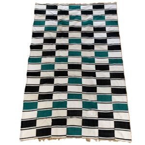 Detail of the checkerboard block pattern with a fringed edge on this handwoven Sahel cotton blanket
