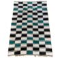 Detail of the checkerboard block pattern with a fringed edge on this handwoven Sahel cotton blanket