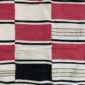 Detail of the checkerboard block pattern framed by pinstripes on this handwoven Sahel cotton blanket