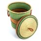 Angled view of the green, orange and black closed laundry basket showing the woven interior