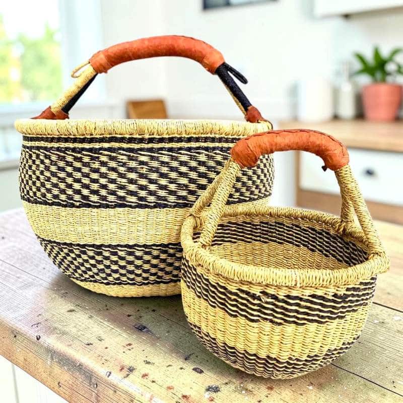 Round Bolga basket duo in black and natural stripe elephant grass with leather handles