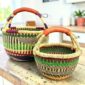 Round Bolga basket duo in green, burgundy and natural elephant grass with leather handles