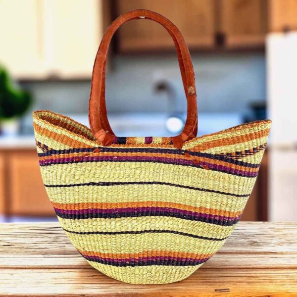 Long handle market basket with fine stripes in muted tones on a natural base and leather-wrapped handles