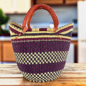 Classic market basket with broad deep-toned bands and chequered sections and leather-wrapped handles