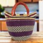 Classic market basket with broad deep-toned bands and chequered sections and leather-wrapped handles