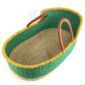 Angled view of the Moses basket with a solid green body, yellow rim, natural base and leather-wrapped handles