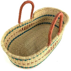 bolga-moses-basket-176-naptime-teal-diamond-elephant-grass-woven-bashiri-2 Angled view of the natural Moses basket showing the teal and blue bands inside and the leather handles