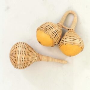 Single and double cane jinglers hand woven from elephant reed in Ghana, shown on a white surface