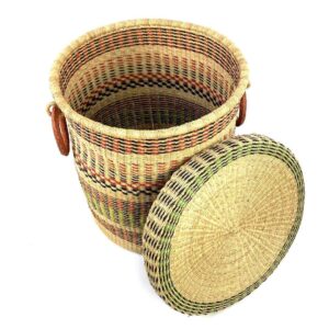 closed-laundry-basket-0304-daal-pink-green-bolga-woven-bashiri-2 The closed laundry basket with its lid off, showing natural straw with pink, green and black bands, a woven lid and leather ring handles