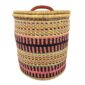 Front view of the closed laundry basket with coral pink and black bands with olive stripes and a woven lid on a white background