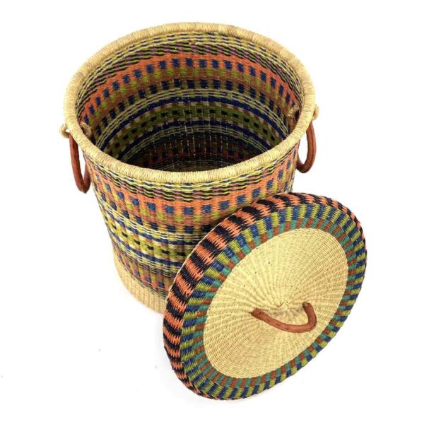 closed-laundry-basket-0306-cupday-multicoloured-striped-bolga-bashiri-2 The closed laundry basket with its lid off, showing multicoloured orange, blue and yellow stripes above a natural base, with a woven lid and leather ring handles
