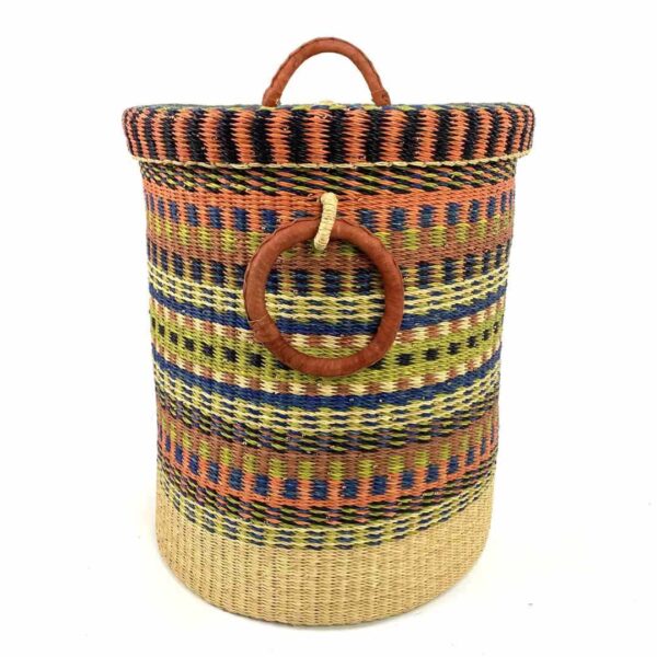 closed-laundry-basket-0306-cupday-multicoloured-striped-bolga-bashiri-3 Front view of the closed laundry basket with multicoloured orange, blue and yellow stripes above a natural base, with a woven lid and leather ring handles on a white background