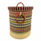Front view of the closed laundry basket with multicoloured orange, blue and yellow stripes above a natural base, with a woven lid and leather ring handles on a white background