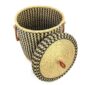 The closed laundry basket with its lid off, showing a black and natural check, a woven lid and leather ring handles