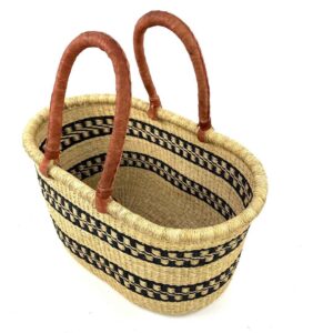 Angled view of the extra large oval Bolga basket with two black stepped bands on natural straw, showing the woven interior