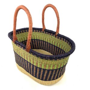 Angled view of the extra large oval Bolga basket with a lime green band between a navy rim and navy lower body, showing the woven interior
